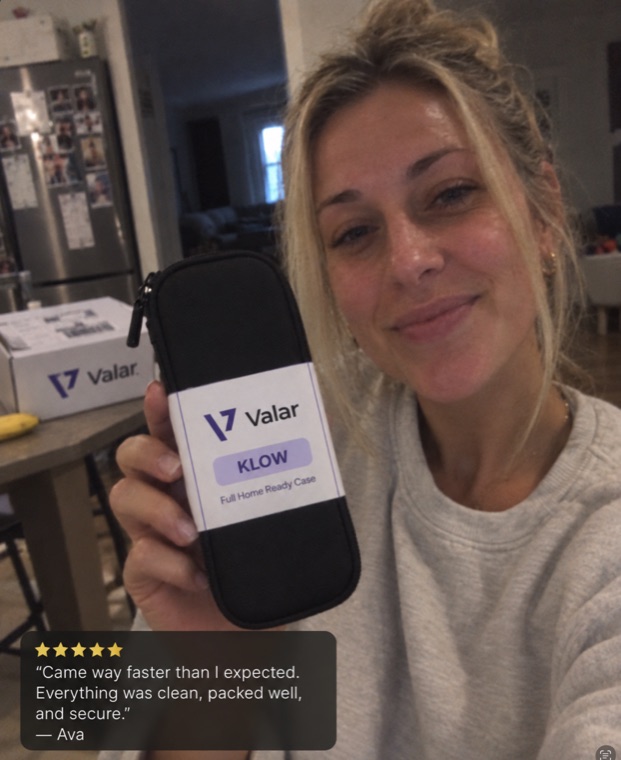 Real customer holding a Valar case, five-star review