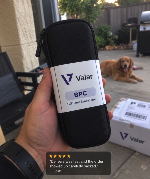 Real customer holding a Valar case, five-star review