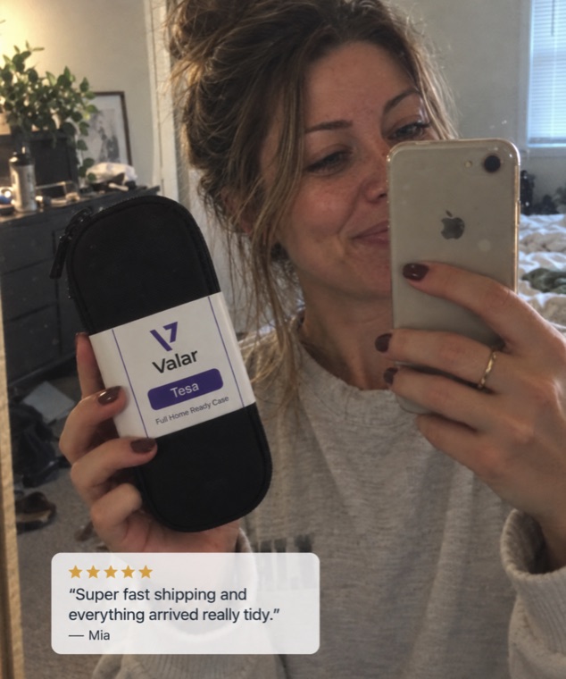 Real customer holding a Valar case, five-star review